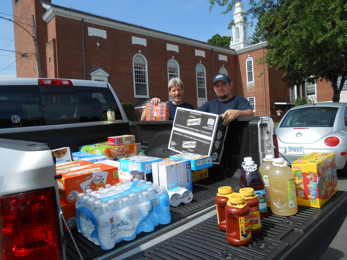 Bill and Andrew unload a donation for the Simsbury Food Pantry | M & M Auto Group