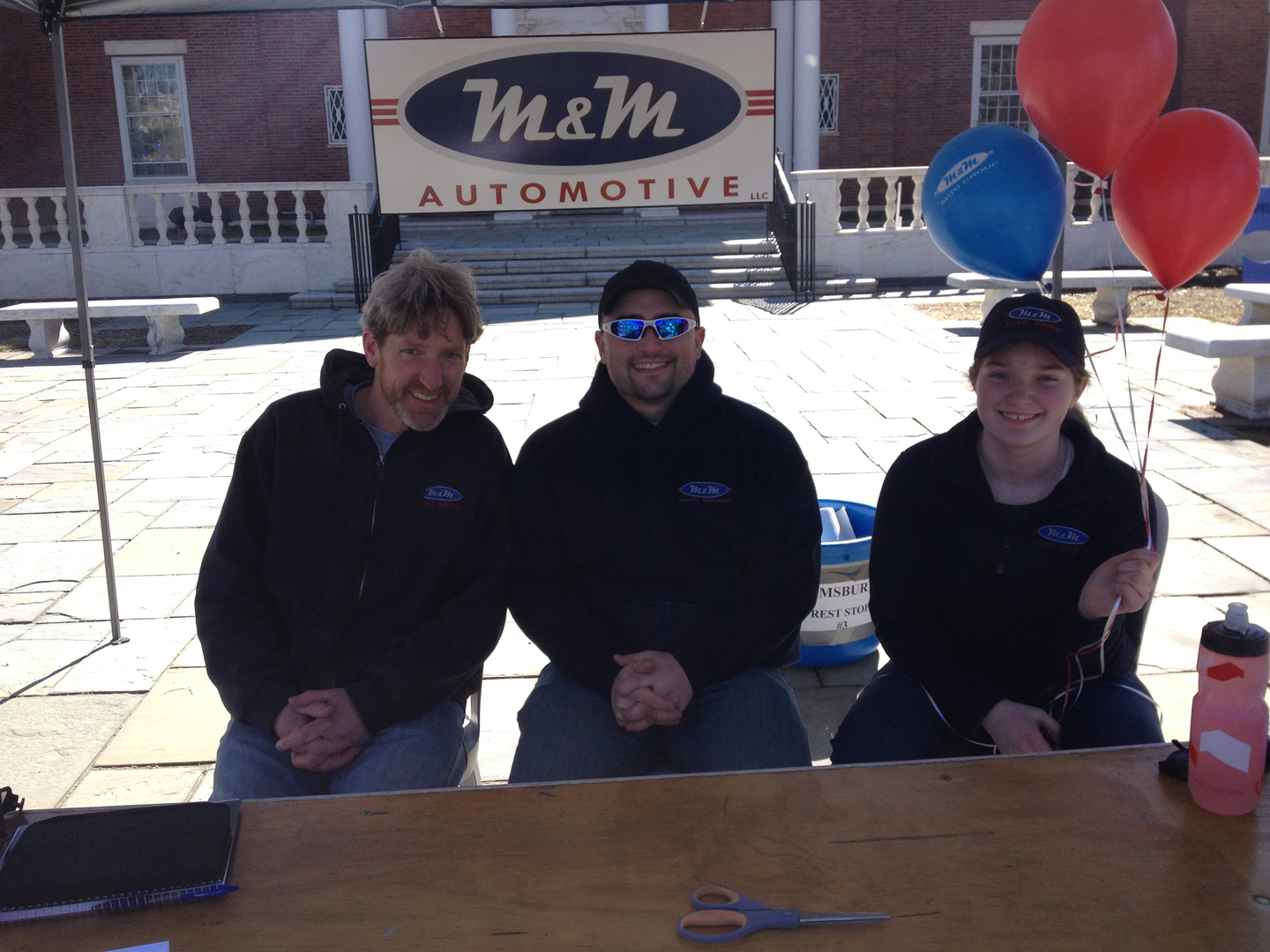 Bill, Ryan, and Meghan man a table at the MS Walk | M & M Auto Group