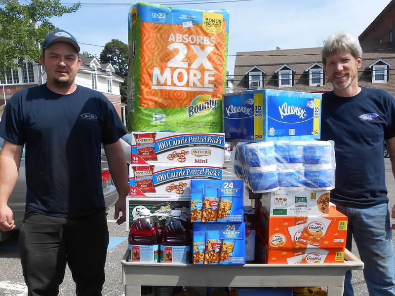 Andrew and Bill present their donation to the Food Pantry | M & M Auto Group