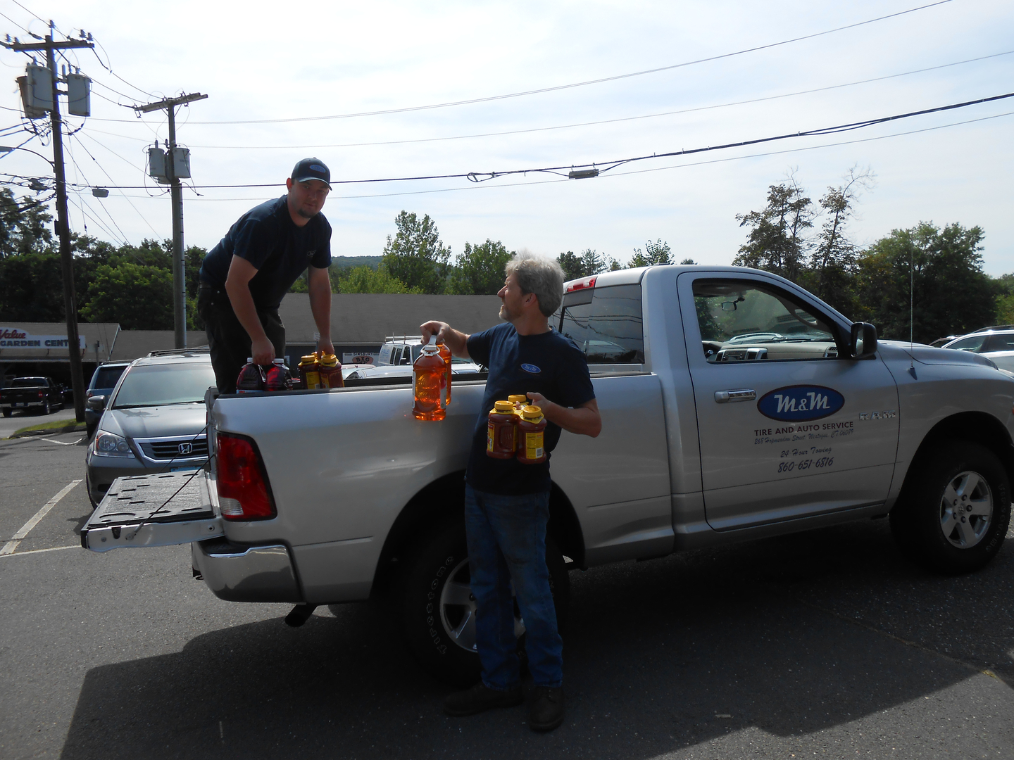 Owner Bill Walsh and Tech Andrew unload supplies at the Simsbury Food Pantry | M & M Auto Group